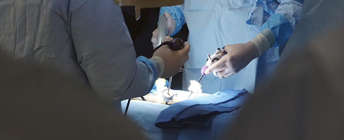 a person in a surgical scrubs holding a syringe