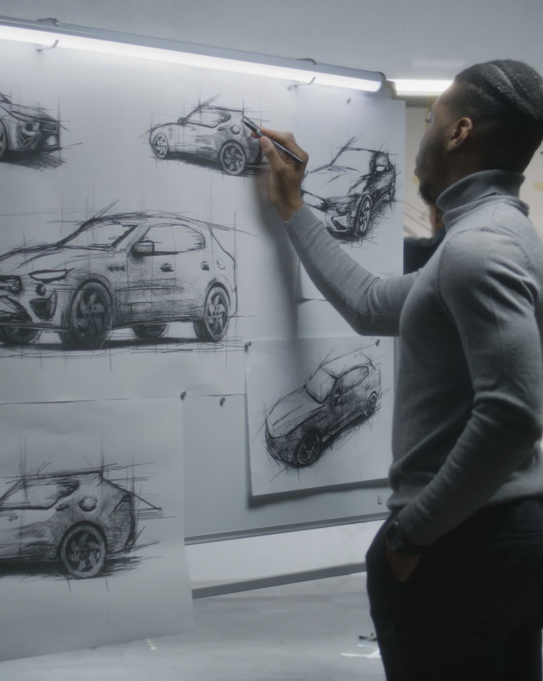 A male designer sketches a concept car
