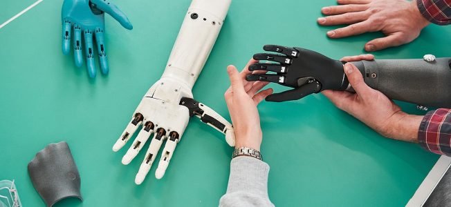 Designers work on a prototype hand prosthetic